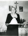 Mrs. Rosa Weigel Holding a Cake