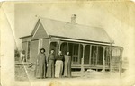 Four Women Standing in Front of a House