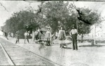 Workers Near a Tool House by Railroad Tracks