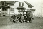 Mlinek Family Standing by an Automobile