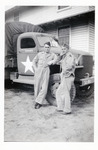 Two Men Standing by Truck