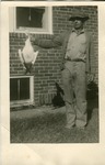 2012-1-355: Man Holding a Goose