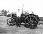 Clyde Hartman Standing Beside a McCormick Tractor