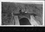 People Sitting on a Concrete Culvert