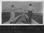 Man and Woman On Railroad Tracks
