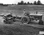 Man On a Tractor Pulling a Hay Baler