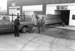 Three Men Next to a Truck Pulling a Solar Collector