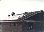 Solar Collectors Being Mounted on Roof