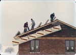 Solar Collectors Being Pulled up on a Roof