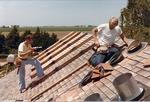 Two Men Preparing Roof for Solar Collectors