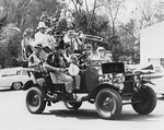 Men in an Antique Car in a Parade