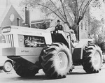 Duane McGinn Driving a Tractor in the Sedgwick Centennial Parade