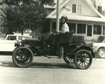 Woman Driving an Antique Car in the Parade