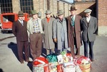 Six men Stand with Gift Baskets