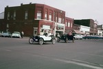 Two Antique Cars in a Parade