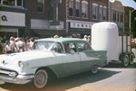 Car Pulling a Trailer in a Parade