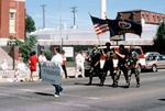 Woman Holds a Sign and a Military Color Guard Carry Flags