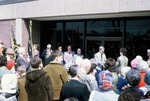 Brad Wells and Shirley Enns in Front of People Outside of the Newton Public Library