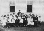 Teacher and Students Outside a Schoolhouse