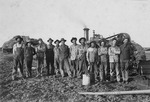 Men Standing in Front of Harvest Machines