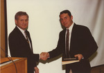 Two Men Shaking Hands at Award Ceremony by Fort Hays State University Athletics