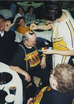Man Getting His Head Painted by Fort Hays State University Athletics
