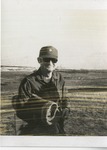 ROTC Instructor Holding Bedroll in Field