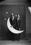 Box 2, Neg. No. 363: Two Men Holding a Paper Moon