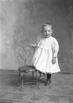 Box 15, Neg. No. 9878: Child Standing by a Chair