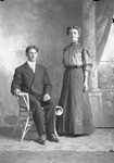 Box 15, Neg. No. 9931: Man Sitting and Woman Standing
