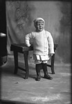 Box 17, Neg. No. 15013: Child Standing by a Table