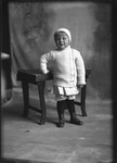Box 17, Neg. No. 15013: Child Standing by a Table