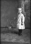 Box 17, Neg. No. 15097: Boy Standing Next to a Chair