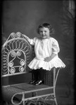Box 18, Neg. No. 18048 - : Girl Sitting on a Chair Arm