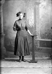 Box 19, Neg. No. 25096: Woman Standing with a Tabletop