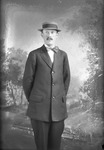 Box 20, Neg. No. 27017: Man Standing in a Suit and Hat