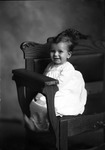 Box 26, Neg. No. 50173: Baby Sitting in a Chair