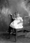 Box 25, Neg. No. 49754: Girl Sitting on a Chair