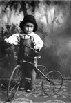 Box 25, Neg. No. 49847: Boy Standing with a Tricycle