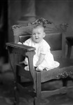 Box 26, Neg. No. 50119: Baby Sitting in a Chair