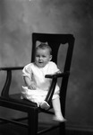 Box 26, Neg. No. 50119R: Baby Sitting in a Chair