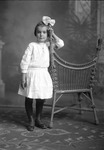 Box 26-2, Neg. No. 34088: Girl Standing Next to a Chair