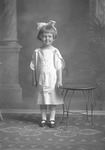 Box 26-3, Neg. No. 38063: Girl Standing Next to a Table