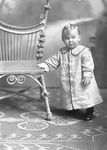 Box 29, Neg. No. 39916: Baby Standing Next to a Chair