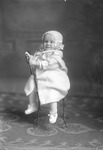 Box 31, Neg. No. 40771: Baby in a Coat Sitting Backwards on a Chair