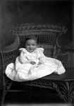Box 32, Neg. No. 6854: Baby Sitting in a Chair