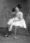 Box 32, Neg. No. 49341: Girl Sitting in a Chair