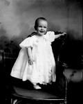 Box 32-2, Neg. No. 2562: Baby Standing on a Chair
