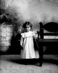 Box 32-2, Neg. No. 1122: Girl Standing Next to a Chair