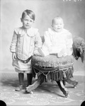 Box 34, Neg. No. 38014: Boy Standing Next to Sitting Baby